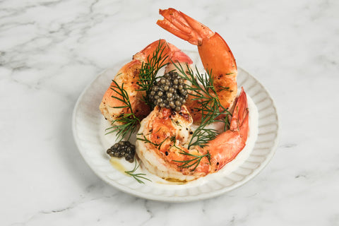 Lemon Prawns with Aioli and Sturgeon Caviar on a white plate.